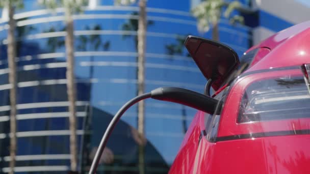 Handsome man opening door, getting out car to pull charging cord from vehicle 6K — Stock Video