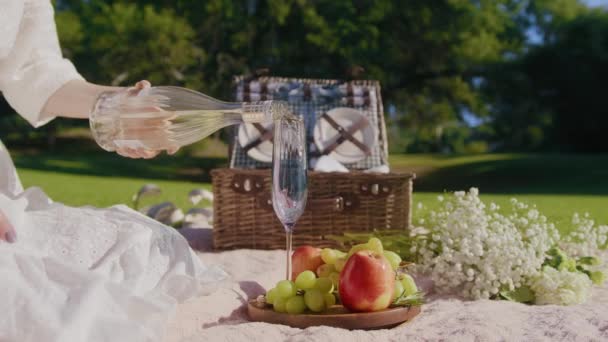 Slow motion lady in white boho dress pouring bubbly champagne in glass flute 6K — Wideo stockowe