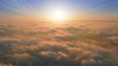 Aerial view Time Lapse direct bright golden sun on blue sky with scenic clouds
