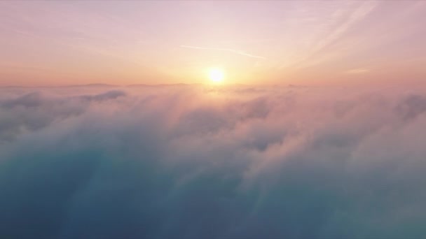 Flying through cinematic rose golden glowing cloudscape towards sunset sun 4K — Stock video