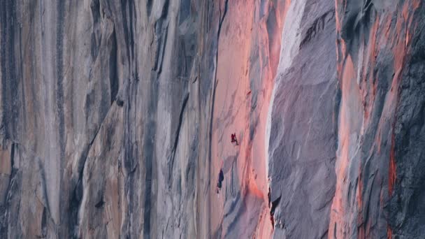 Mountain climber hanging on rope on El Capitan mountain in cinematic sunset 6K — Stock video