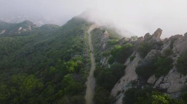 Two persons hiking outdoor by cinematic green mountain trail, 4K outdoor nature