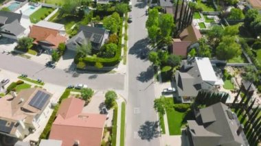 Aerial footage of high end area with wealthy villas and lush gardens