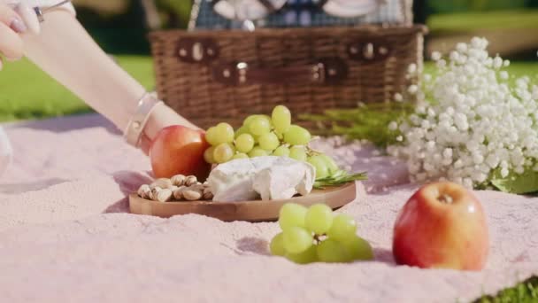 Closeup female hand taking slice of mold cheese, french cheese on fruits board — Stock Video