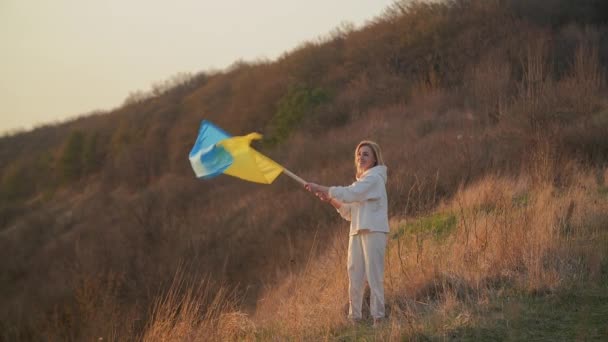 Młoda Blondynka Macha Ukraińską Flagą Zachodzie Słońca Sobie Biały Garnitur — Wideo stockowe