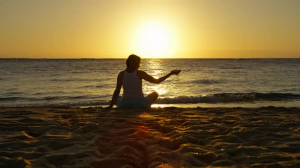 Silhouette Woman Sitting Golden Sand Cinematic Sunset Spilling Sand Fingers — Stockvideo