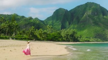 Cinematic nature of idyllic summer escape destination. Aerial footage of a woman running towards the jaw-dropping view of mountains covered with endemic rainforest and jungles. High quality 4k footage