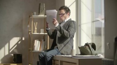 Angry man throws a stack of documents and screams. Tired, emotional office worker yelling after analyzing the papers. High quality FullHD footage