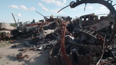 March, 2022. Bucha, Ukraine. Devastated blown-up private vehicles of killed Ukrainian people after Russian invasion. Close-up view of abandoned broken and burnt vehicles. High quality 4k footage