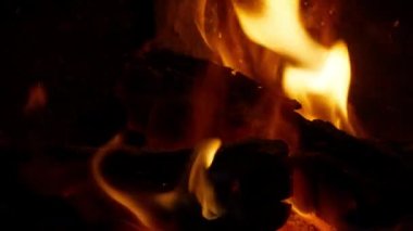 Burning Log Fire Flames in Fireplace Close-up Slow Motion, RED camera footage. Winter Holidays, Merry Christmas celebration, Family traditional gathering in one home concept background with copy space
