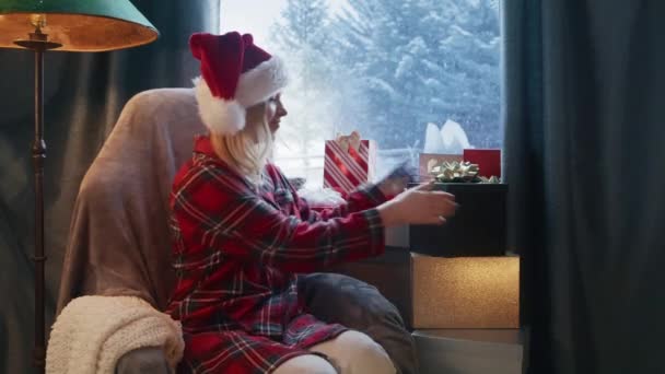 Christmas Spirit Happy Woman Red Santa Hat Sitting Armchair Window — Stockvideo