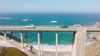Self driving autonomous cars driving by scenic bridge with radar technology scanning distance between vehicles. Artificial intelligence traffic system providing safety driving avoid traffic jams 4K