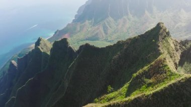 Wilderness outdoor adventure trip, copy space nature background. Bird eye aerial view above lavish greenery peaks of breathtaking Napali coast National park on Kauai Hawaii island on sunny summer day
