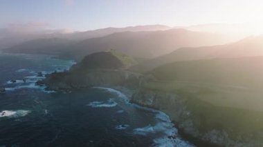 High ridges by the wilderness coastline within magnificent beauty. Drone footage of beautiful vistas of Big Sur along scenic drive along national park. High quality 4k footage