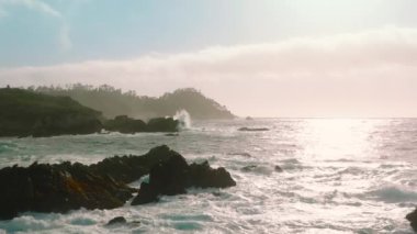Aerial view of 17-Mile Drive in Picturesque Pebble Beach, nature park in California, West Coast. Beautiful coastline with redwood forests and beaches with sunrise skyline. High quality 4k footage