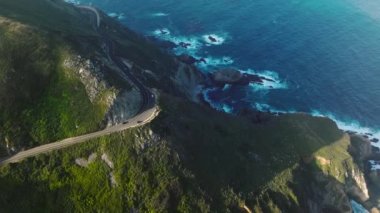 Drone footage of scenic Central shore of California, USA. Pristine land where the ocean meets the lush green landscape with steep cliffs. High quality 4k footage