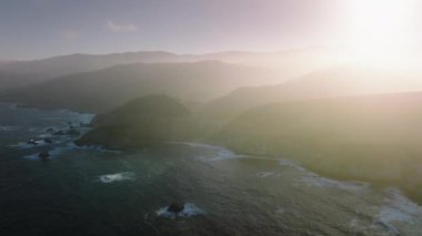 Aerial view of California Scenic Byway with sunset skyline in the background. The Monterey Bay National Marine Sanctuary as seen from above. High quality 4k footage