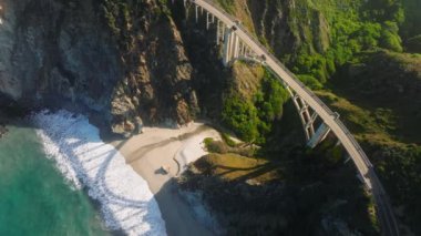 Drone footage of the Bixby Creek Bridge from its southern end. Cinematic views of the stretch of California shoreline as seen from above. High quality 4k footage