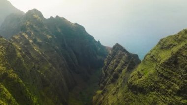 Aerial incredible mountain ridge with epic views of Awaawapuhi Trail, Kokee State nature park on Na Pali coast of North Shore Kauai island, Hawaii USA. Cinematic natural sunny landscape background 4K