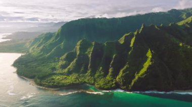 Aerial pure nature environment of tropical island Kauai Hawaii. Cinematic nature aerial of world famous coastline. Outdoors adventure dream travel. Epic green jungle mountain coast nature background