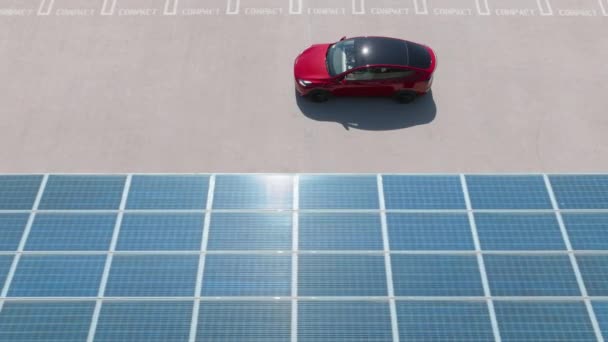 Aerial View Red Car Driving Parking Lot Solar Panel Roof — Vídeo de Stock