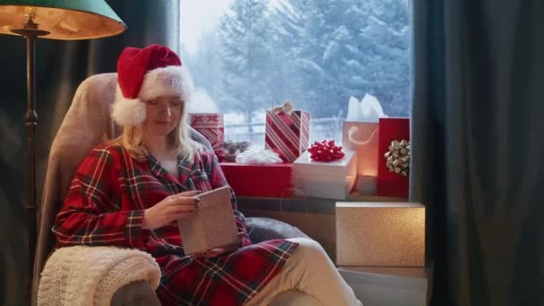 Blonde Woman Funny Red Santa Claus Hat Sitting Cozy Living — Vídeo de Stock