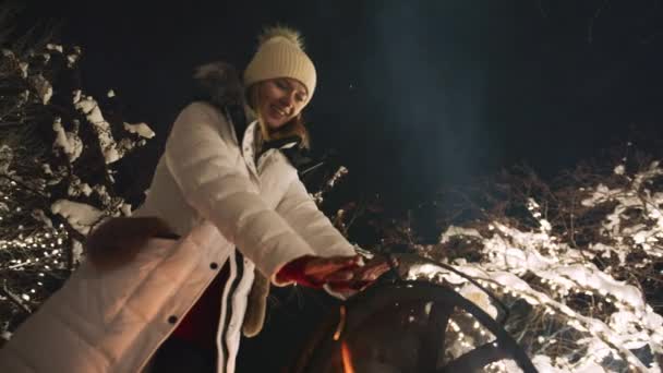 Smiling Woman Warming Hands Bonfire Ski Mountain Resort Magic Winter — Stock videók