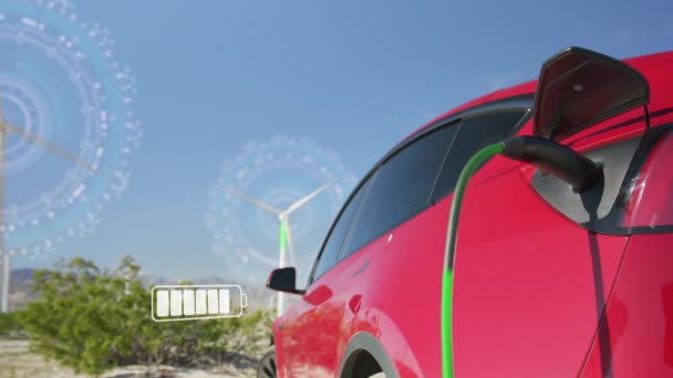 Red Electric Car Charging Background Rotating Windmills Sunny Windy Day — Stok video