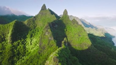 Sunny landscape tropical rain forest jungle island Kauai on background majestic ancient volcano in Na Pali nature park. 4K aerial view majestic green mountain peaks of Hawaii island, nature background