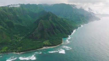 Drone footage of Napali coastline stretching on the north shore of Kauai, Hawaii, USA. Iconic, mountainous shoreline with extraordinary natural beauty. High quality 4k footage