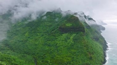 Helicopter tour above scenic areas of the Napali Coast, Hawaii, USA. Drone footage of impressive Jurassic Park backdrop with adventurous trails. High quality 4k footage