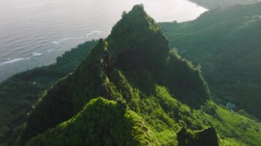 Aerial footage of Haena Beach with crystal clear water and green park. Breathtaking views of adventurous destination with deep valleys covered in tropical greenery. High quality 4k footage