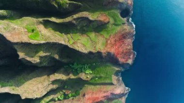 Beautiful nature drone flying above deep blue ocean coast at remote Hawaii island, mountain beach on Na Pali coast park, Kauai Hawaii island 4K America. Breathtaking aerial dramatic mountains backdrop