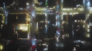 Aspen town aerial overhead view at night with snow winter time Christmas. Fly over winter streets with night illumination. Street lights and small town traffic, night drone video birds view, Colorado