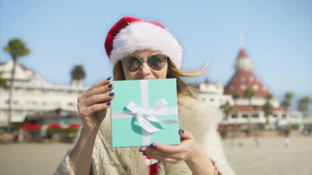 Smiling Woman Santa Claus Hat Beach Wishing Merry Christmas Congratulates — Vídeos de Stock