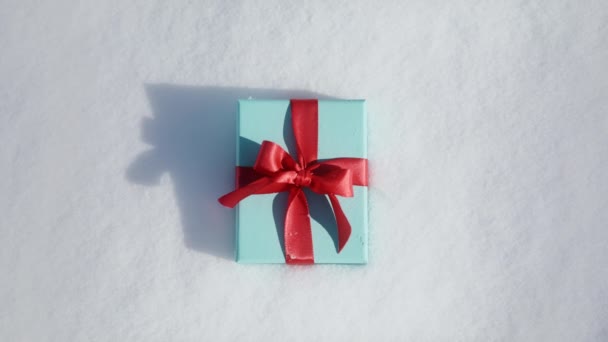 Beautiful Small Teal Box Elegant Scarlet Bow White Snow Texture — Stock Video