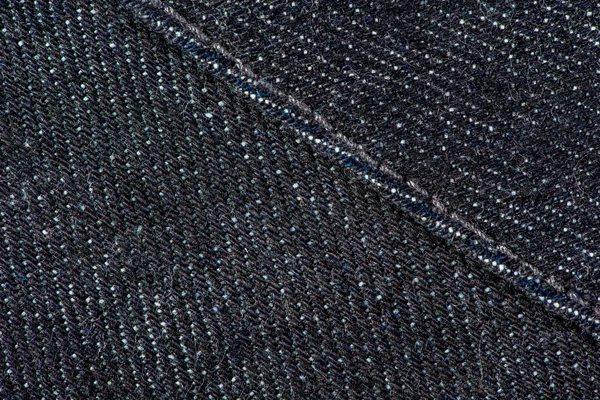 Ciemno niebieskie Spodnie jeansowe z szwów i szew tekstura tło. — Zdjęcie stockowe