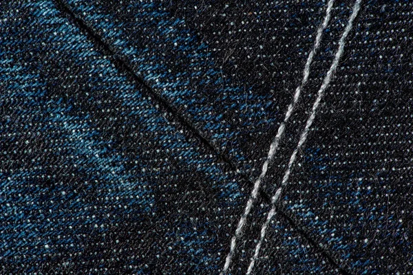 Jeans blu scuro in denim con punti di sutura e fondo texture cucitura . — Foto Stock