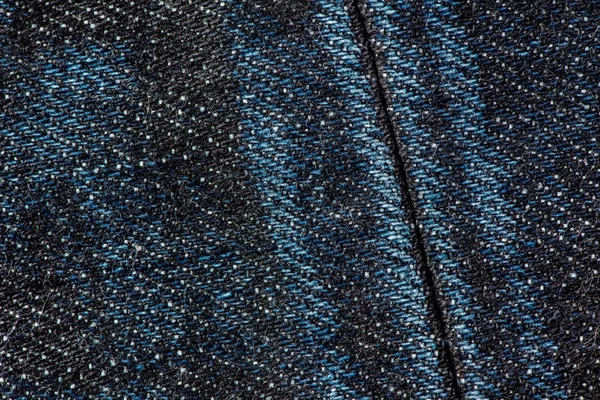 Blauwe denim jeans met naad textuur achtergrond. — Stockfoto