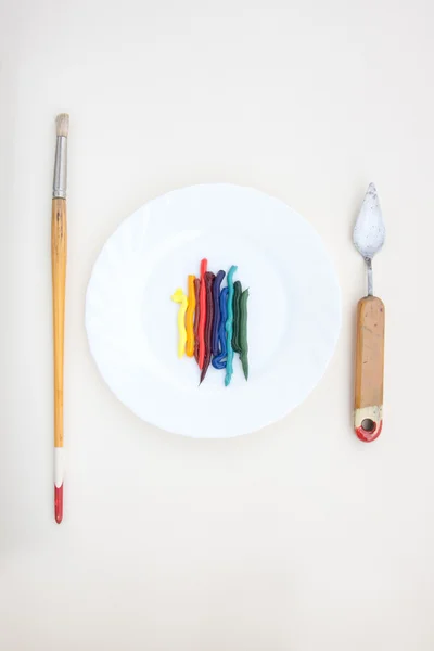 Oil paint served like a dish with vintage painting instruments — Stock Photo, Image