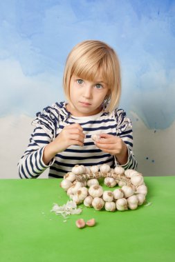 Little pretty girl peeling garlic clipart