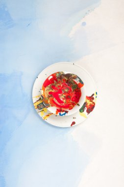 Beyaz ve mavi bir arka plan üzerinde boya ile beyaz fincan ve bir fincan tabağı lekeli