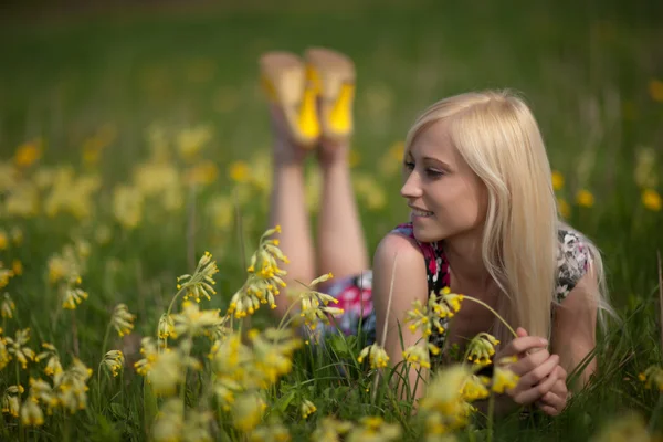 Girl in larkspur field — Stock Photo, Image