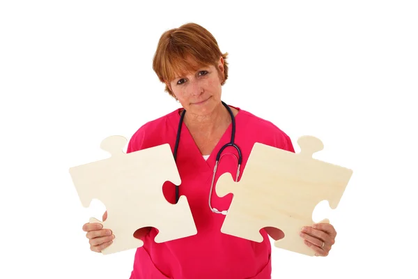 Krankenschwester hält Puzzleteile in der Hand — Stockfoto