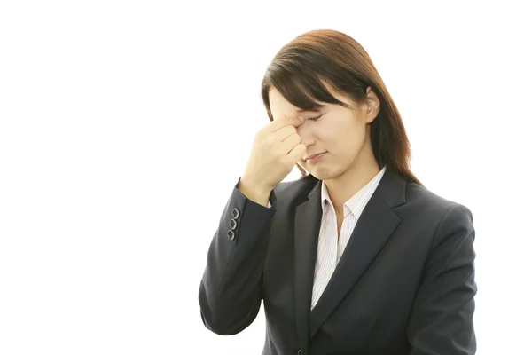 Business woman having a headache — Stock Photo, Image