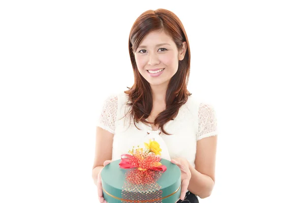 Woman smiling with a gift — Stock Photo, Image