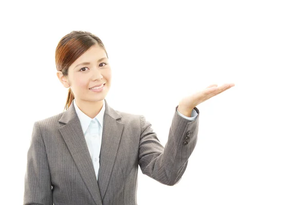 Business woman showing something on the palm of her hand — Stock Photo, Image