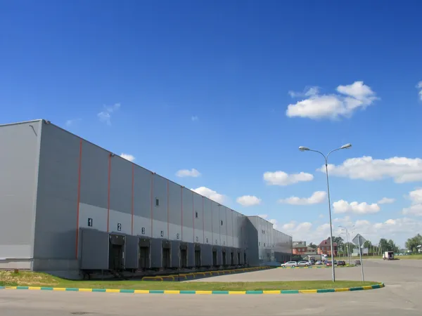 Modern grey warehouse with parking lot — Stock Photo, Image