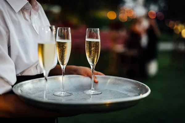 Luxury wine and CHAMPAGNE  for fine dining with and glassware, beautiful blurred  background. For events, weddings.  props for weddings, birthdays, and celebration. Wedding, restaurant.