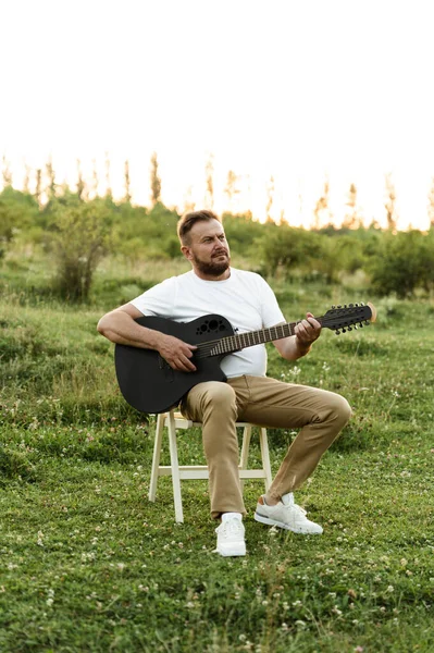 Middle Aged Man Sitting High Chair Playing Guitar Nature — Stock Photo, Image